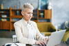 professional woman works in an office on a laptop computer